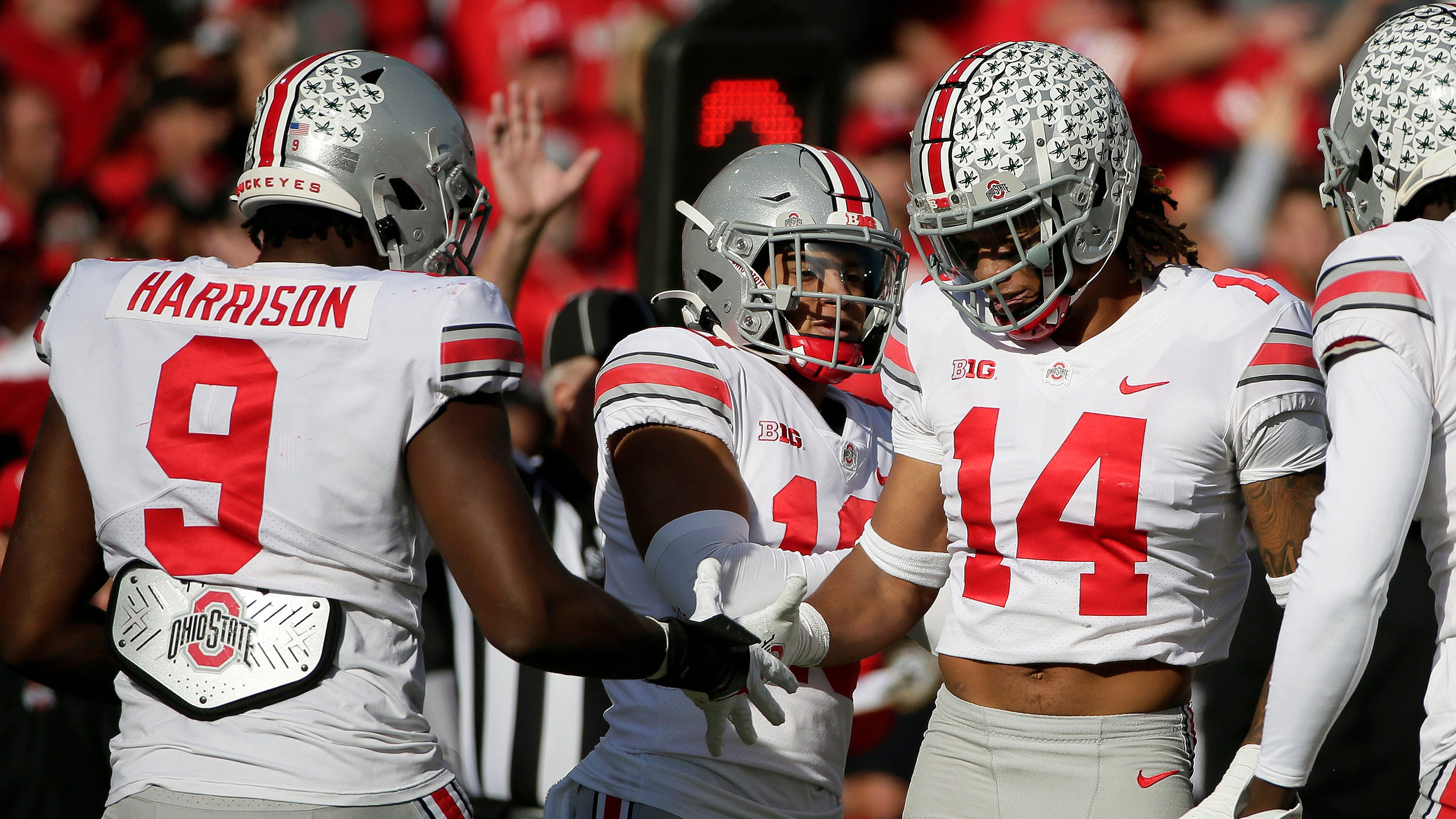 Ohio State players celebrate a sack of Nebraska